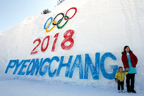 © AP/Lee Jin-man Frau mit Kind vor dem in Eis gemeißelten Schriftzug 2018 Pyeongchang