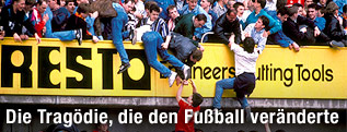 Stadionbesucher fallen von überfüllter Tribüne